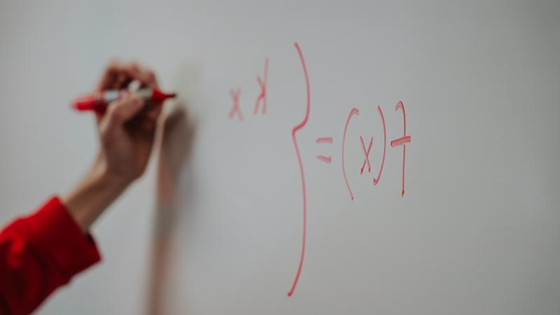 Math problem on whiteboard